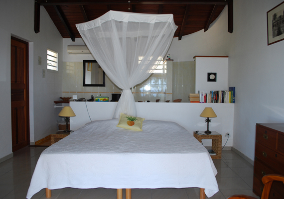 Chambre mitoyenne au salon avec une salle de bain totalement ouverte sur la chambre. Toutes les chambres sont équipées de climatisation.